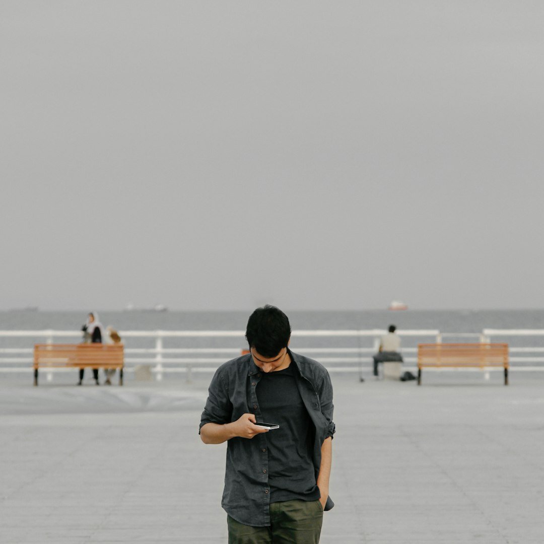 Man checking breaking news alerts on his smartphone